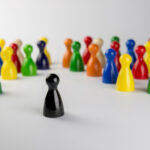 Conceptual game pawns that depict the concept different.